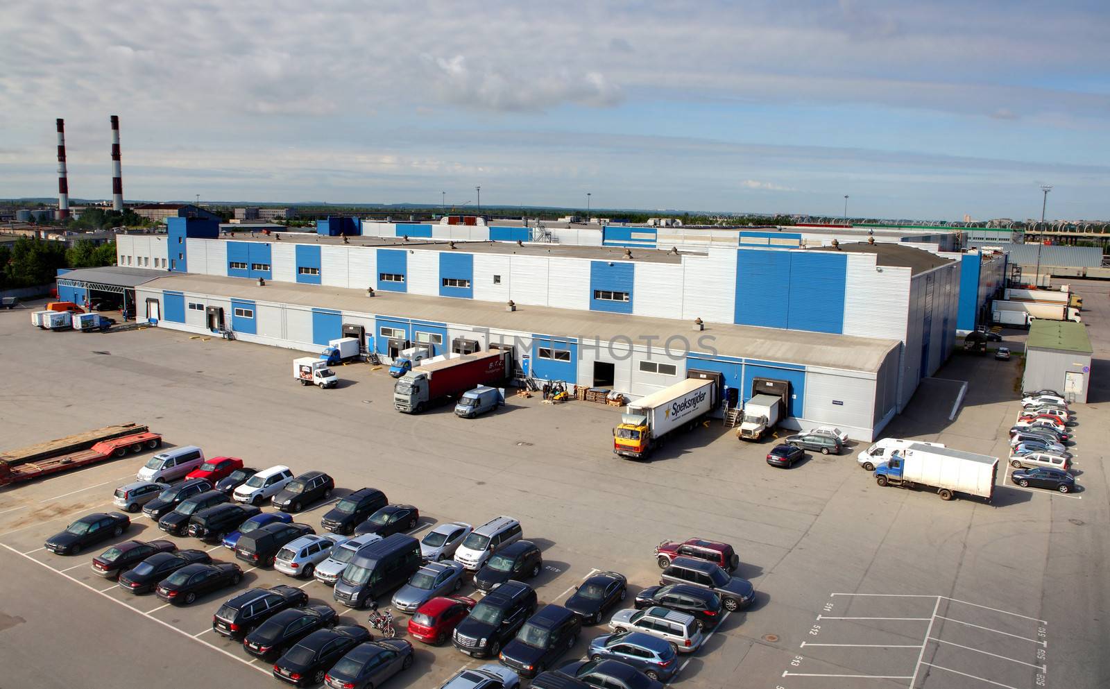 ST-PETERSBURG, RUSSIA - JUNE 13: Unloading and loading on a large, modern warehouse complex,  13 June 2013.  Warehouse of Interterminal with material handling area and parking. Trucks are unloaded at the warehouse, loading and unloading.