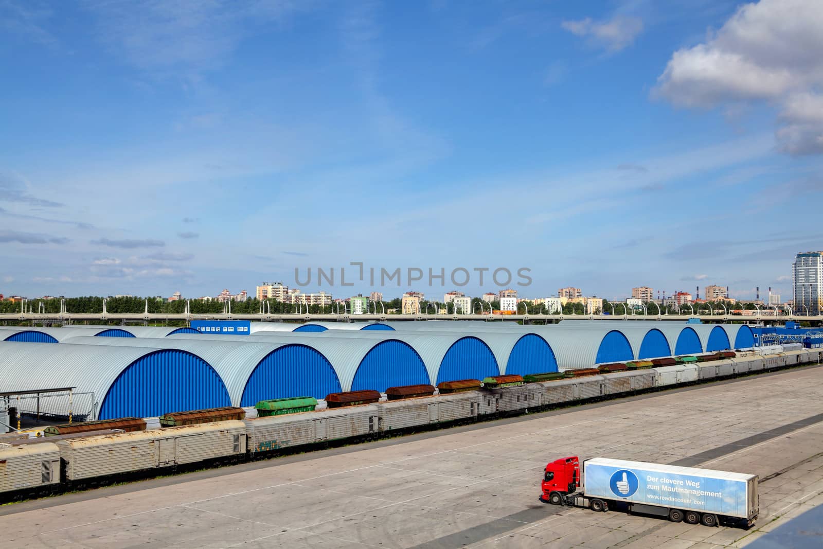 Blue hangars warehouses, lined in a row, a few buildings. by grigvovan