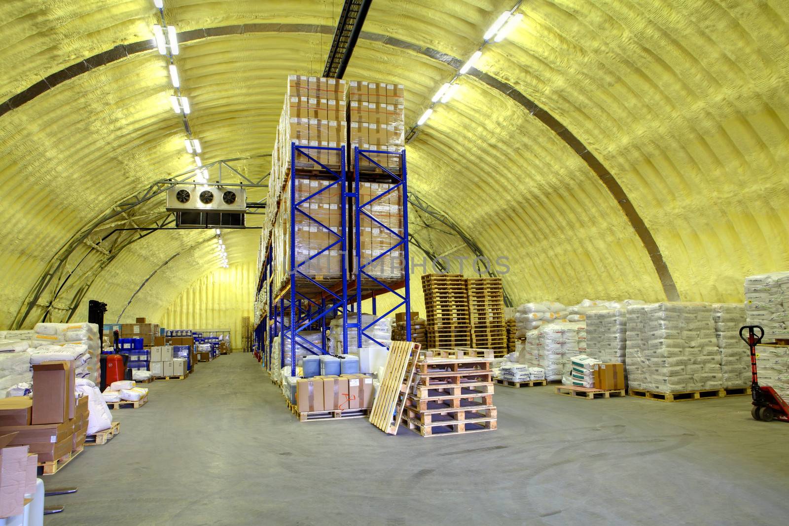 warehouse hangar of polyurethane foam, storage hangar with shelves and goods by grigvovan