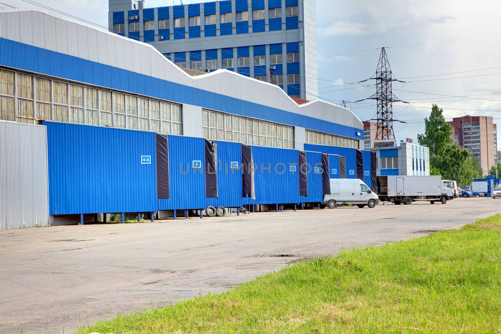 loading and unloading area of warehouse, row of  loading docks  by grigvovan