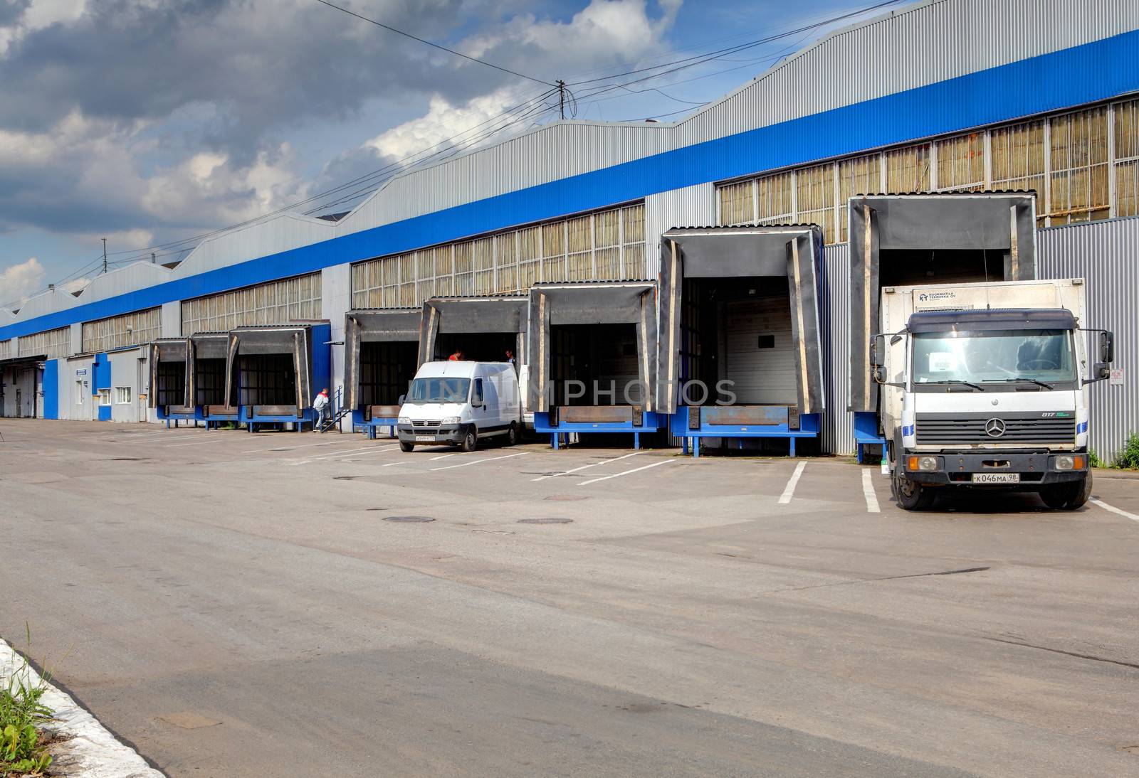 loading and unloading area of warehouse, row of  loading docks  by grigvovan