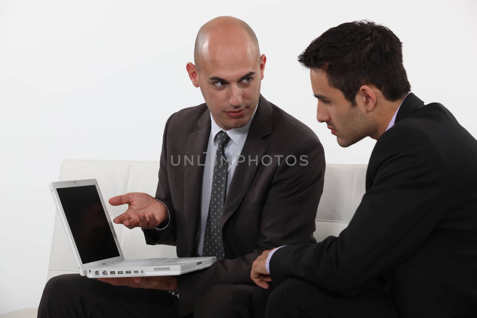 Businessman explaining his work to colleague by phovoir