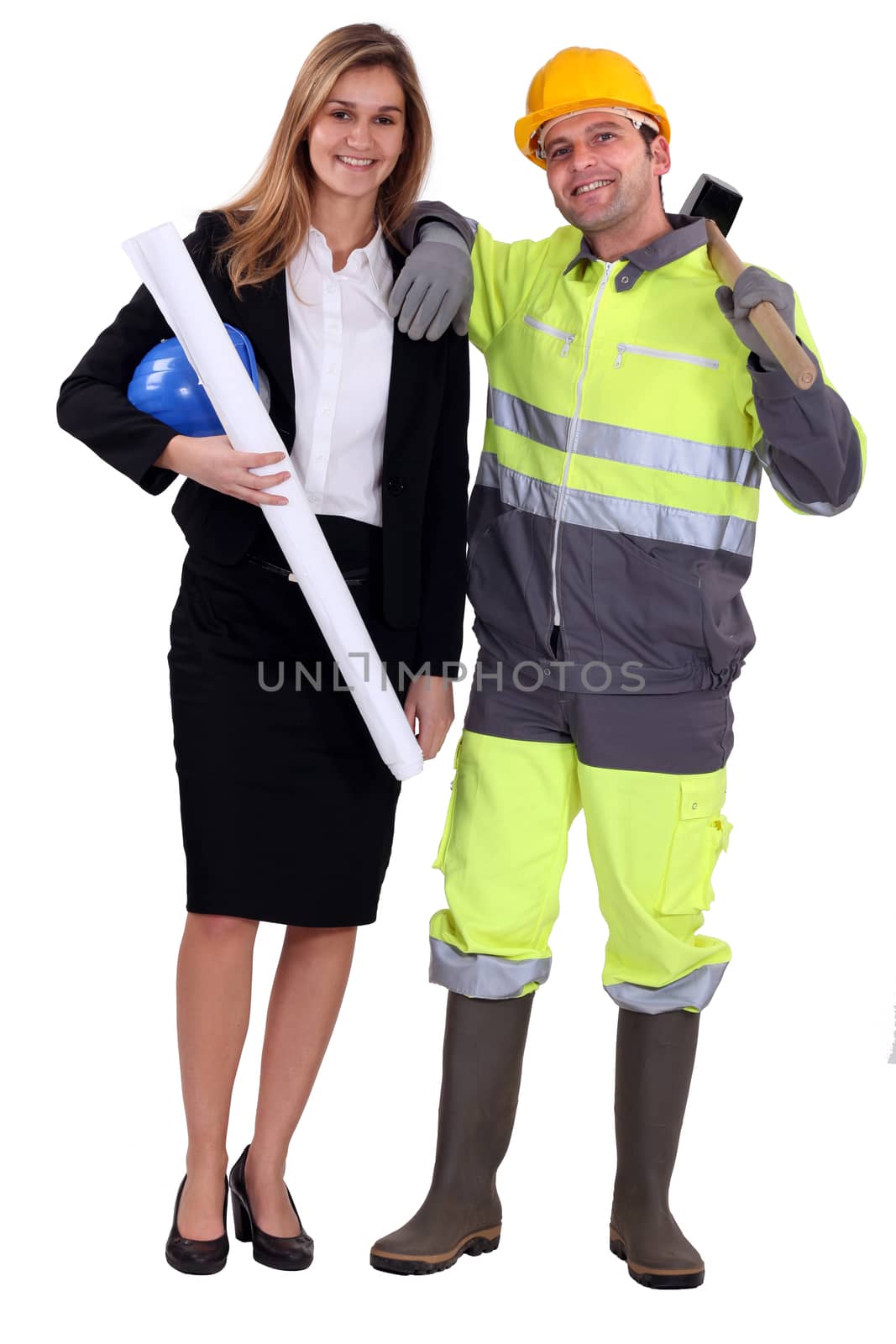 Female architect stood with manual worker by phovoir