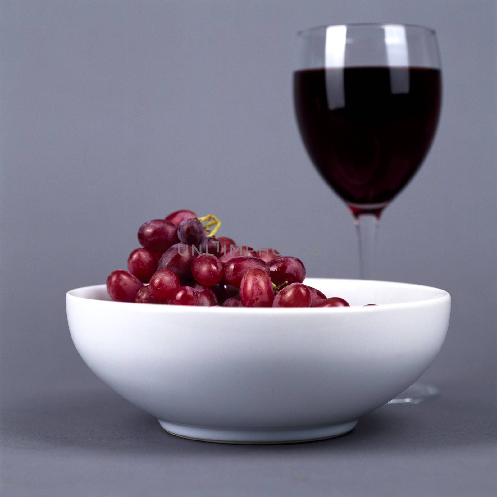 Glass of Red Wine and Grapes by Whiteboxmedia