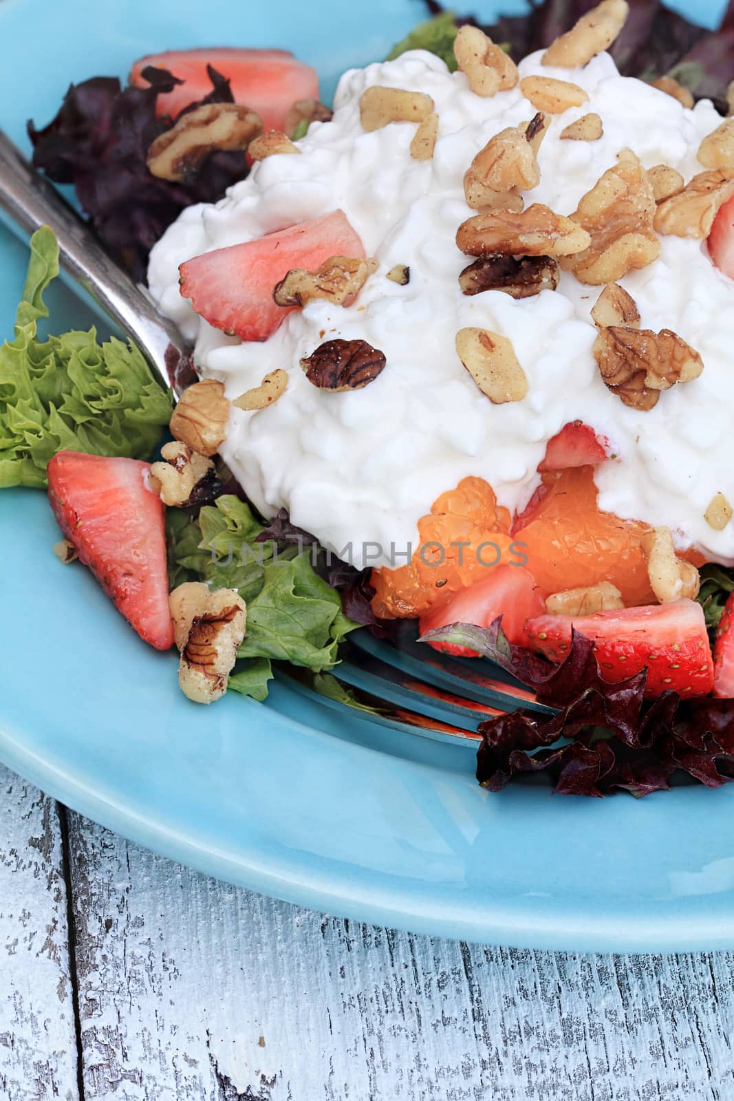 Strawberry and cottage cheese salad with mandarin oranges and walnuts. 