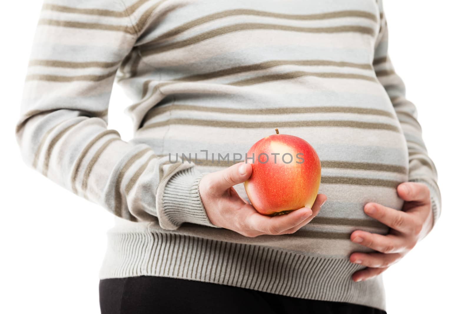 Pregnant woman hand holding red raw ripe apple fruit by ia_64