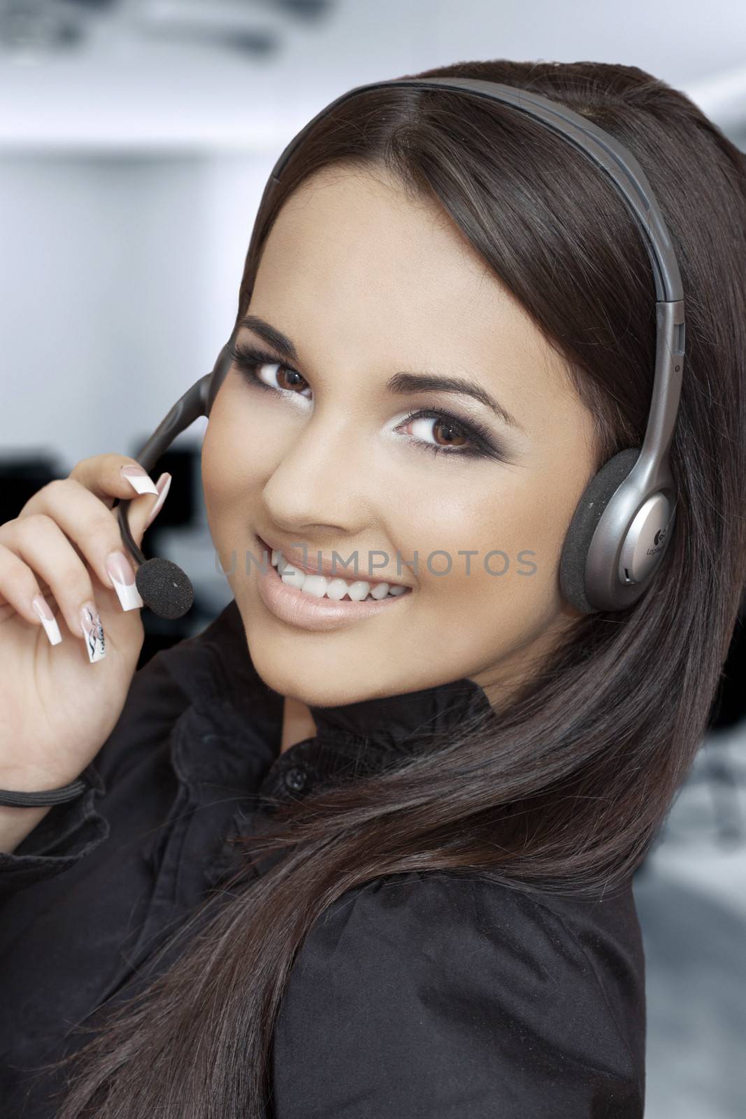 beautiful girl with a headset looking at the camera 