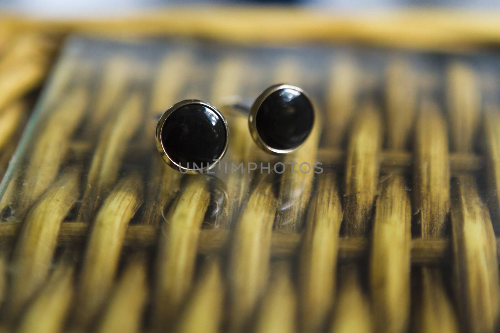 Close up of a couple cufflinks on a wodden table