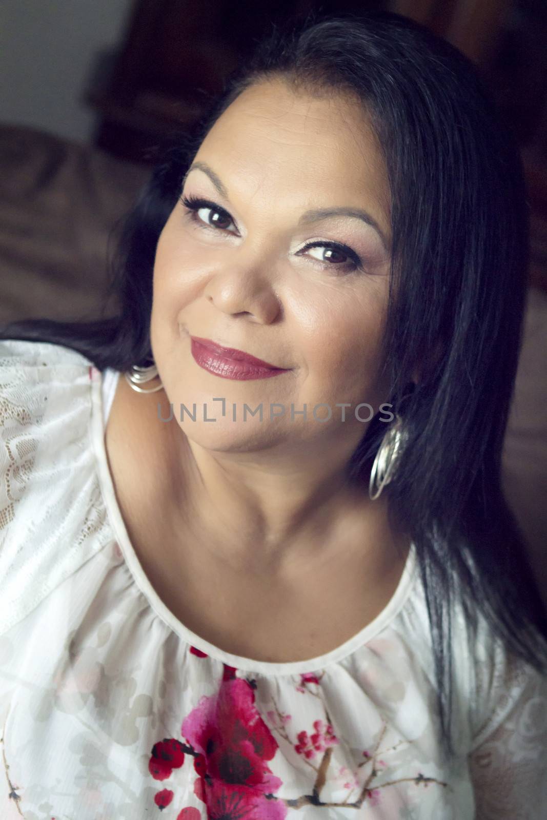 Close up portrait of a pretty hispanic woman in her 50s