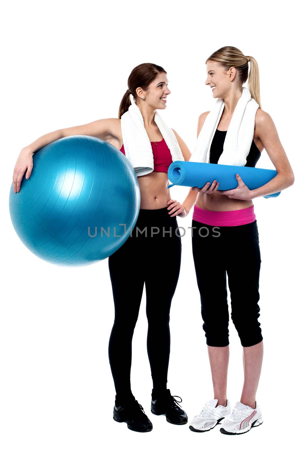 Two girls communicating after workout by stockyimages