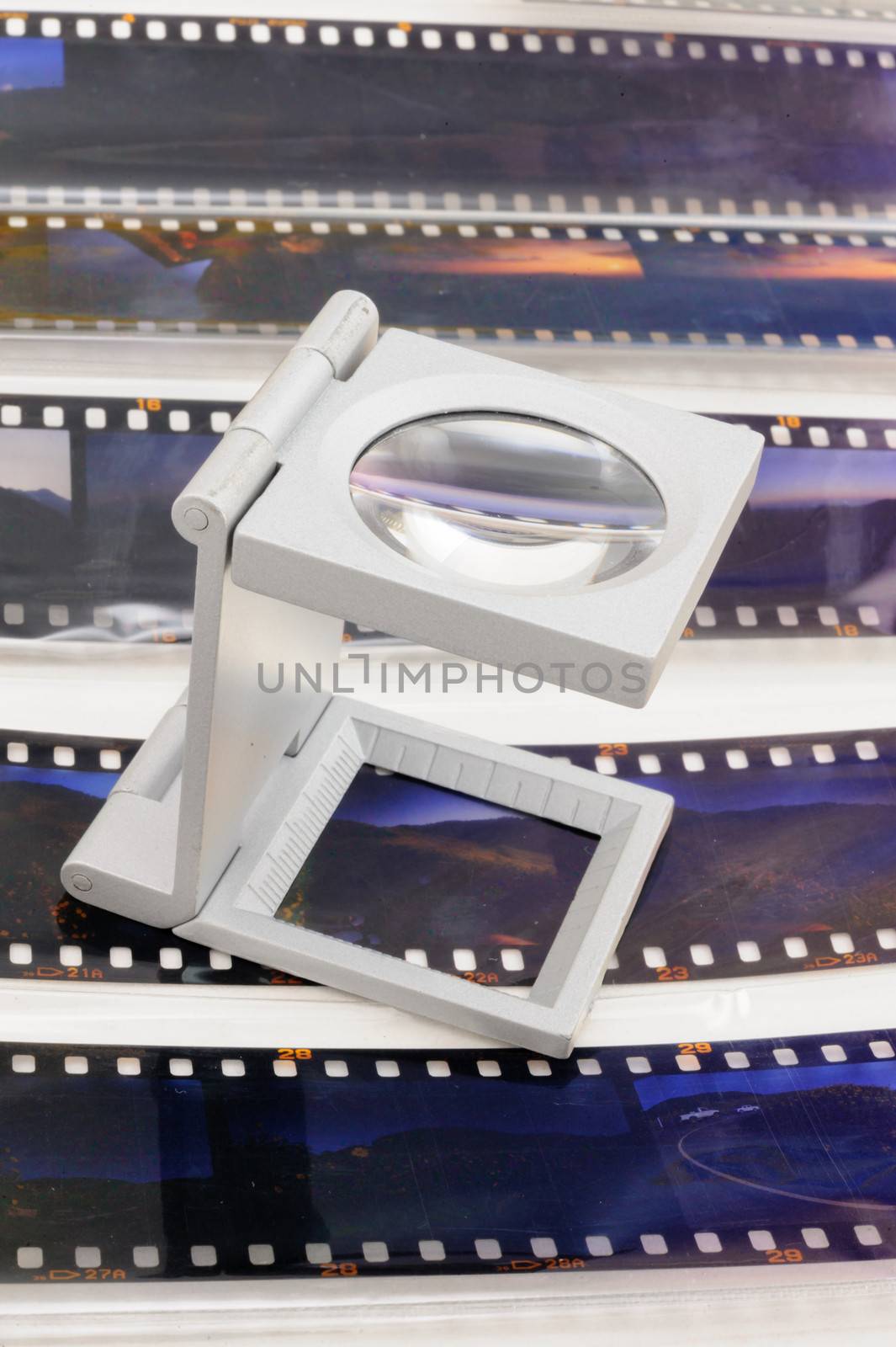 Magnifier loupe over transparency film slide. by ngungfoto