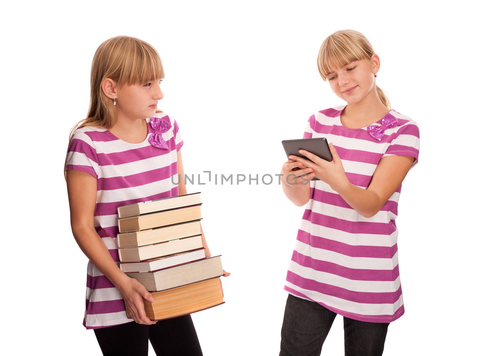 Books vs ebook reader - One girl holding lots of books and watching enviously another girl reading an ebook reader and smiling.