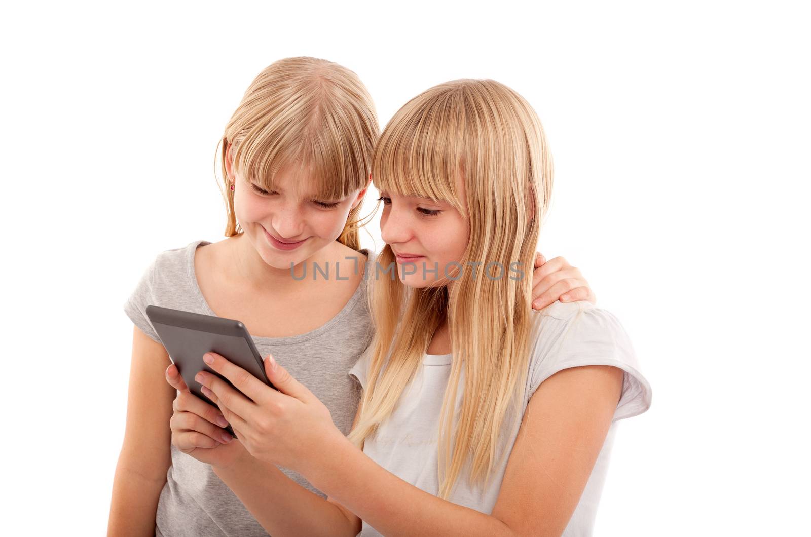 Young females reading something funny in an ebook reader tablet device.