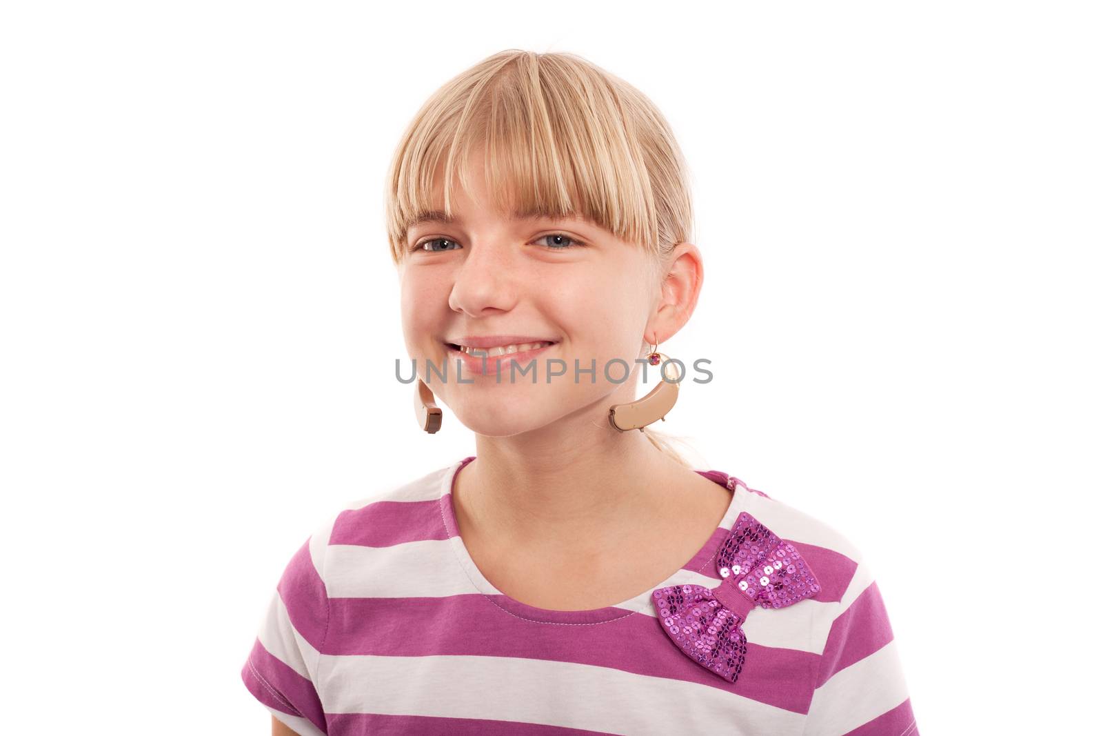 Girl joking with hearing aids using them as earrings. Isolated on white.