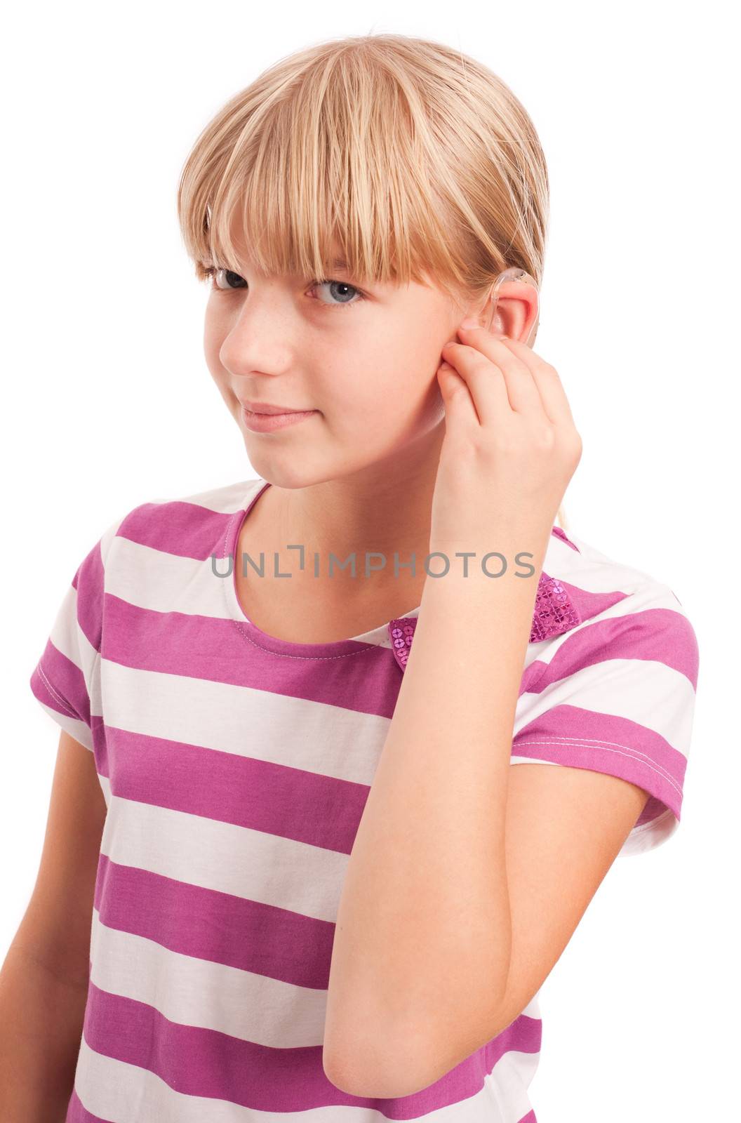 Hearing aid - Young Girl setting her hearing aid. Isolated on white.