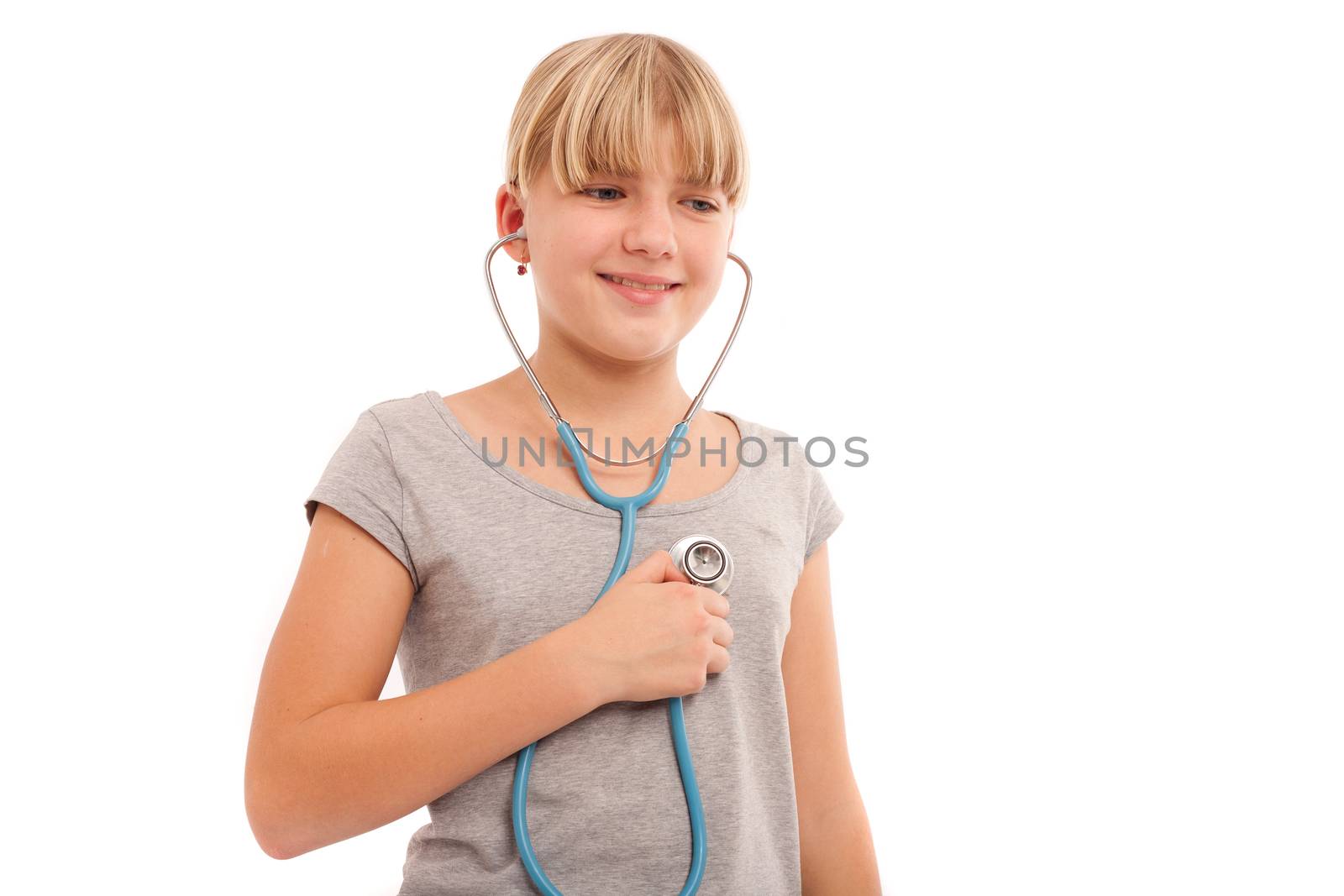 Self check - Young female checking herself with a stethoscope