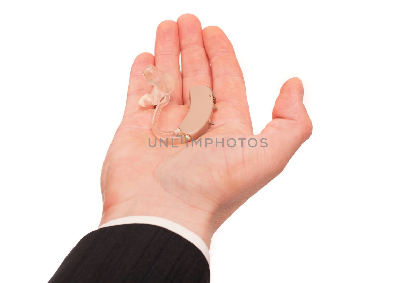 Man's hand holding a hearing aid isolated on white