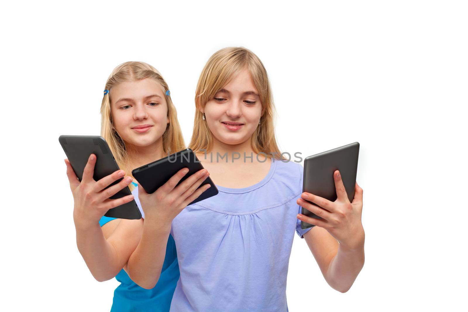 Tablets and ebook readers - Two girls playing with several tablets/ebook readers. Isolated on white.