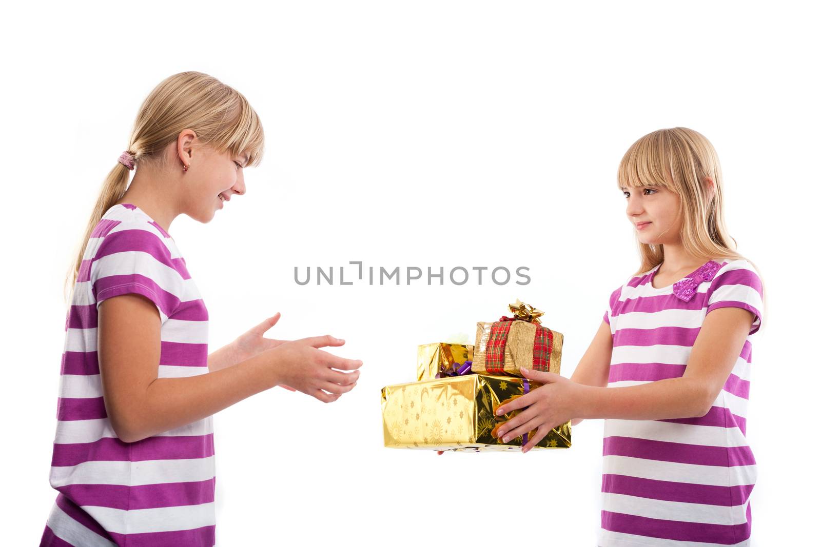 Girl fiving  gifts to another girl isolated on white background