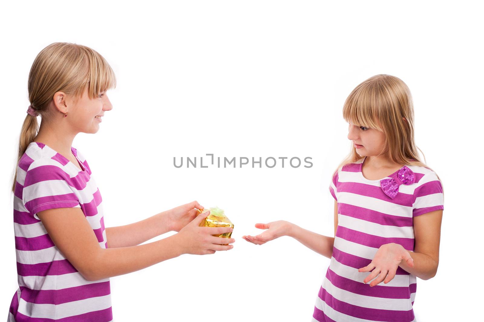 Girl giving a gift to another Girl who is shocked because the gift is too small