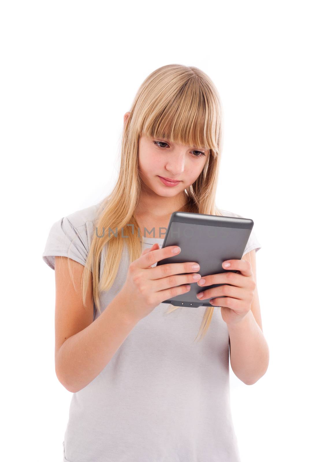 Ebook reader - Young girl reading an ebook using a reader isolated on white