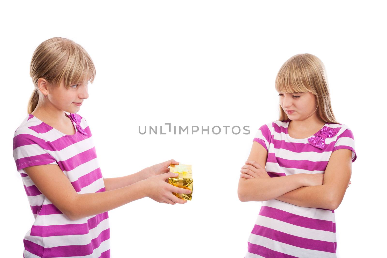 Girl giving a gft to another Girl who is disappointed because the girt is too small