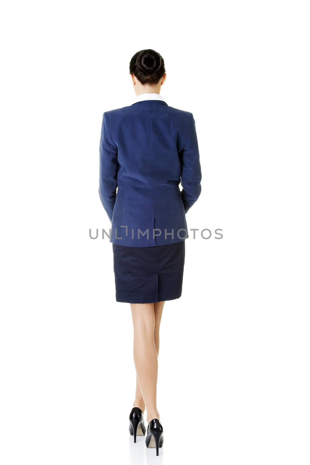 Rear view of young beautiful businesswoman, isolated on white