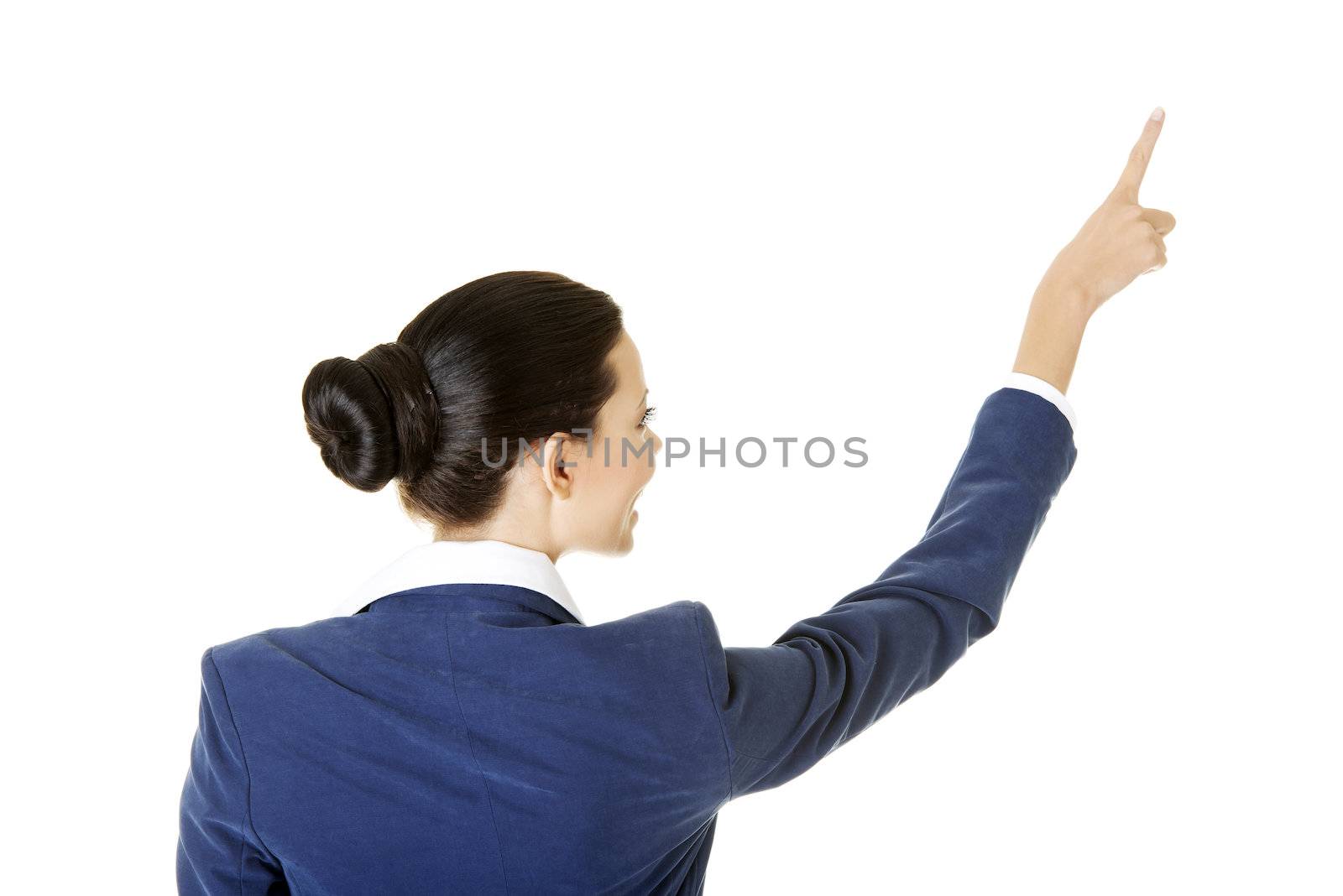Happy young business woman pointing on copy space, isolated on white