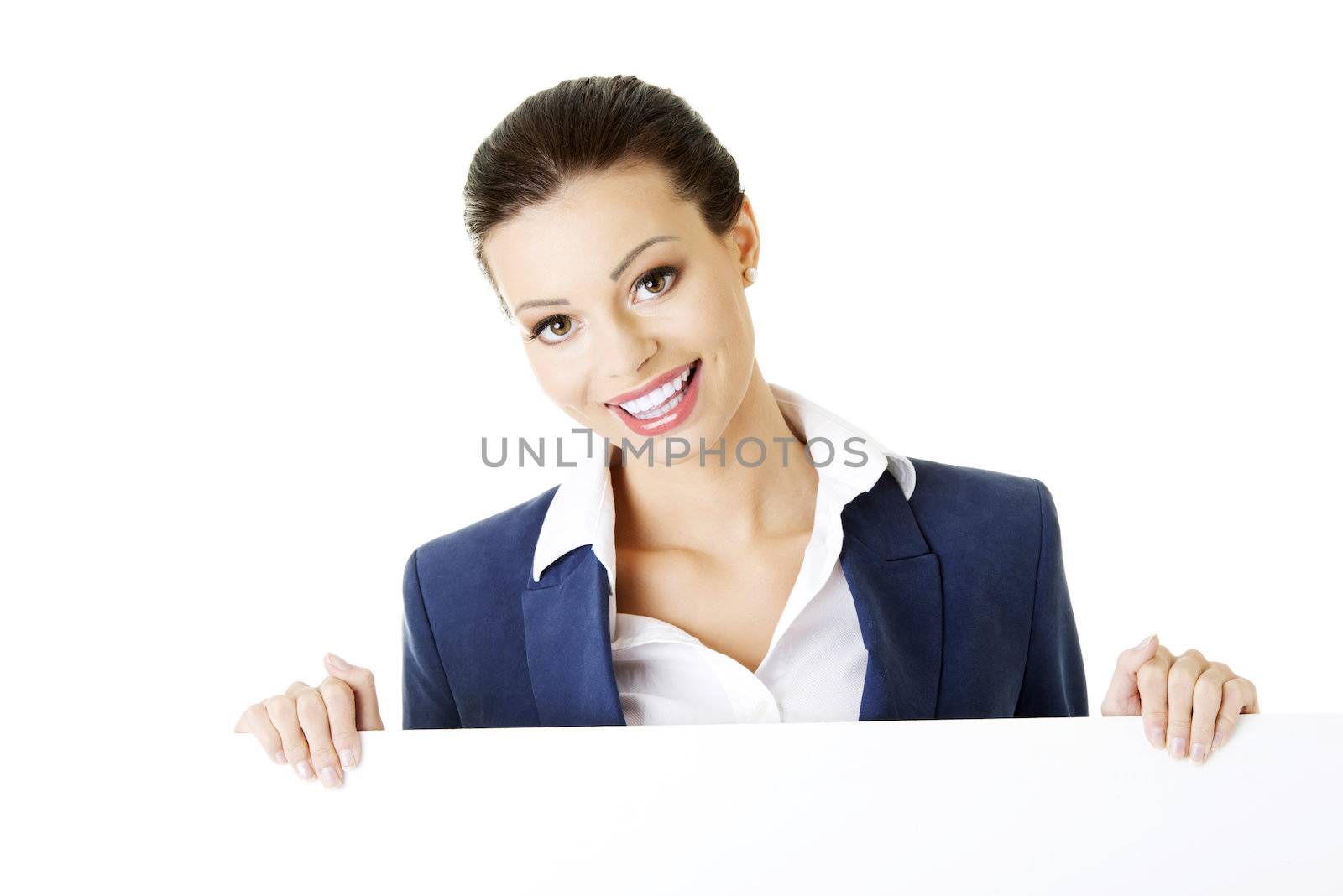 Smiling attractive businesswoman showing blank signboard, over white background isolated