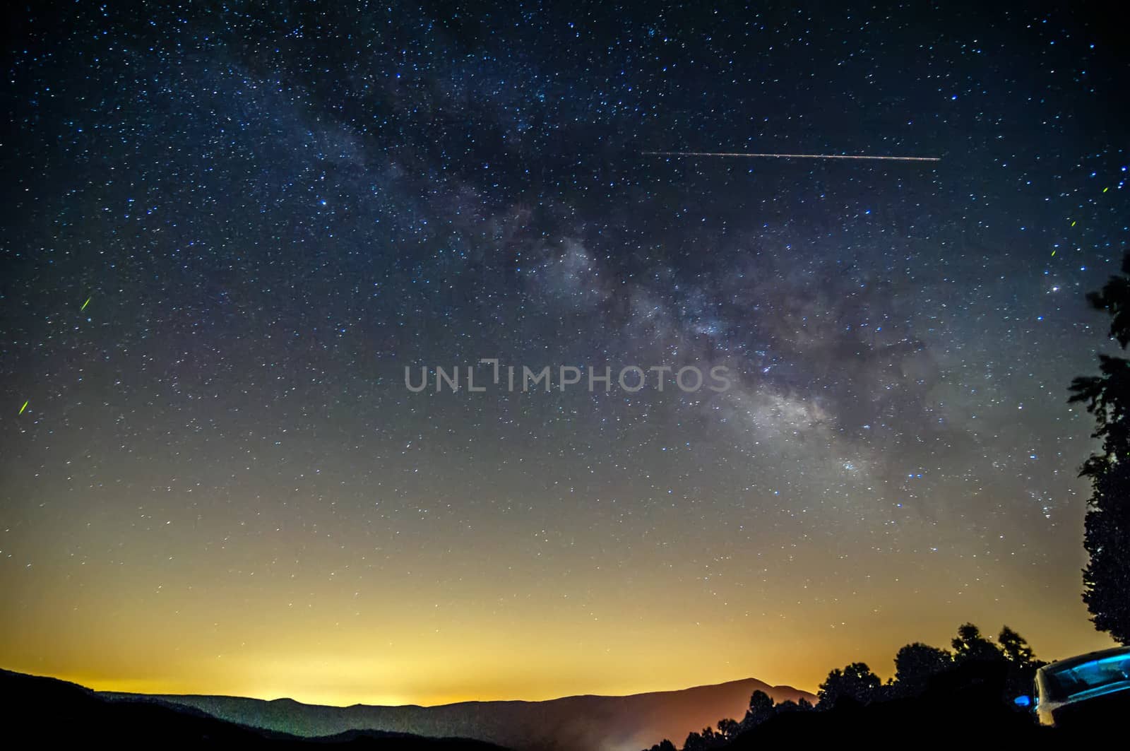 Milky way over the city lights and mountains on blue ridge parkway