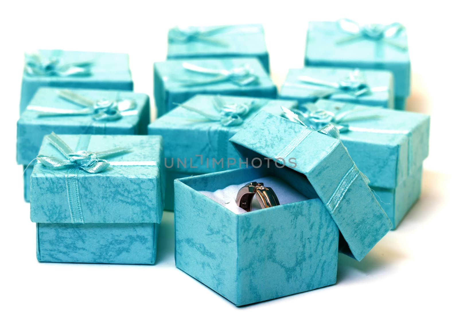Cyan gift boxes with ring closeup on white background