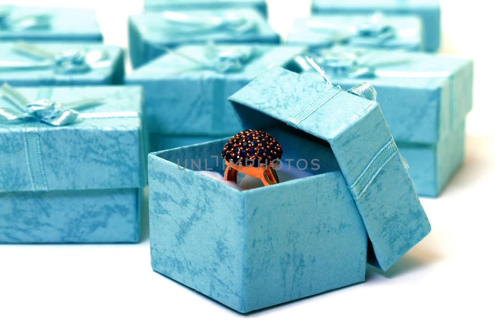 Cyan gift boxes with ring closeup on white background