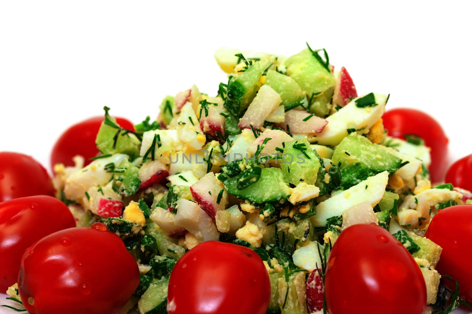 Salad with potatoes, eggs, cherry tomatoes, closeup on white background