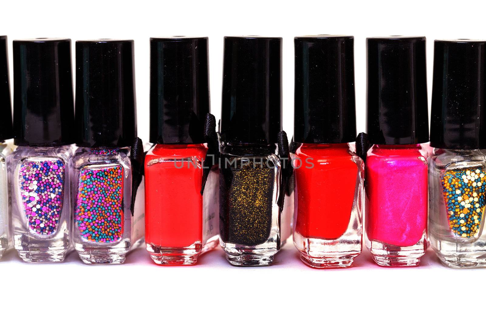 Group of bright nail polishes on white background