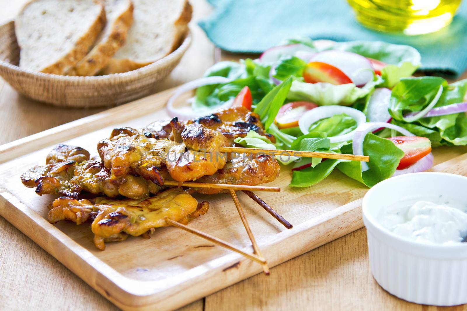 Grilled chicken skewer with salad by vanillaechoes