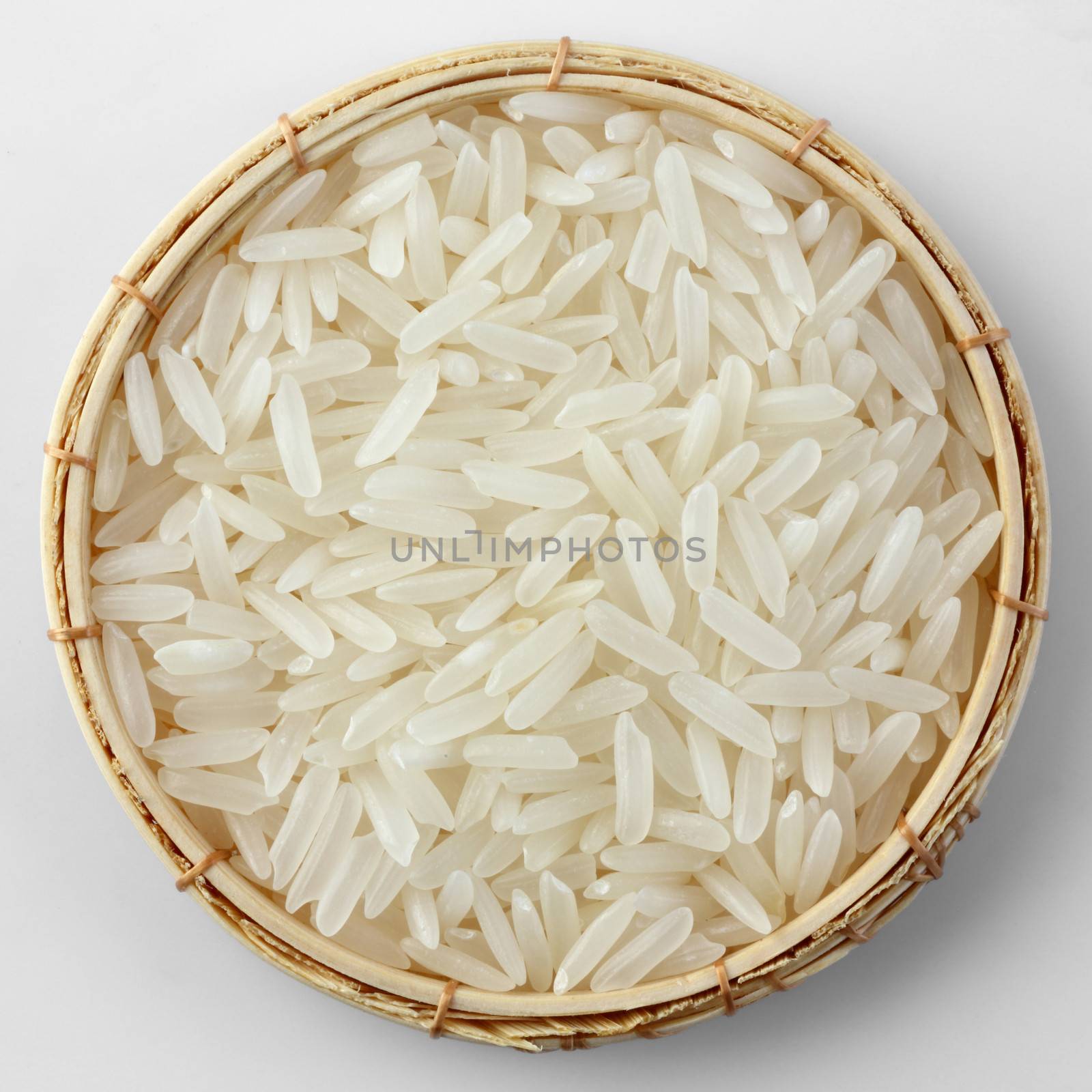 Thai jasmine rice in bamboo basket isolated on white