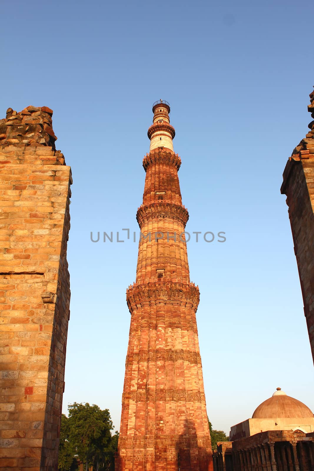 qutub minar with unconstructed gate and tomb