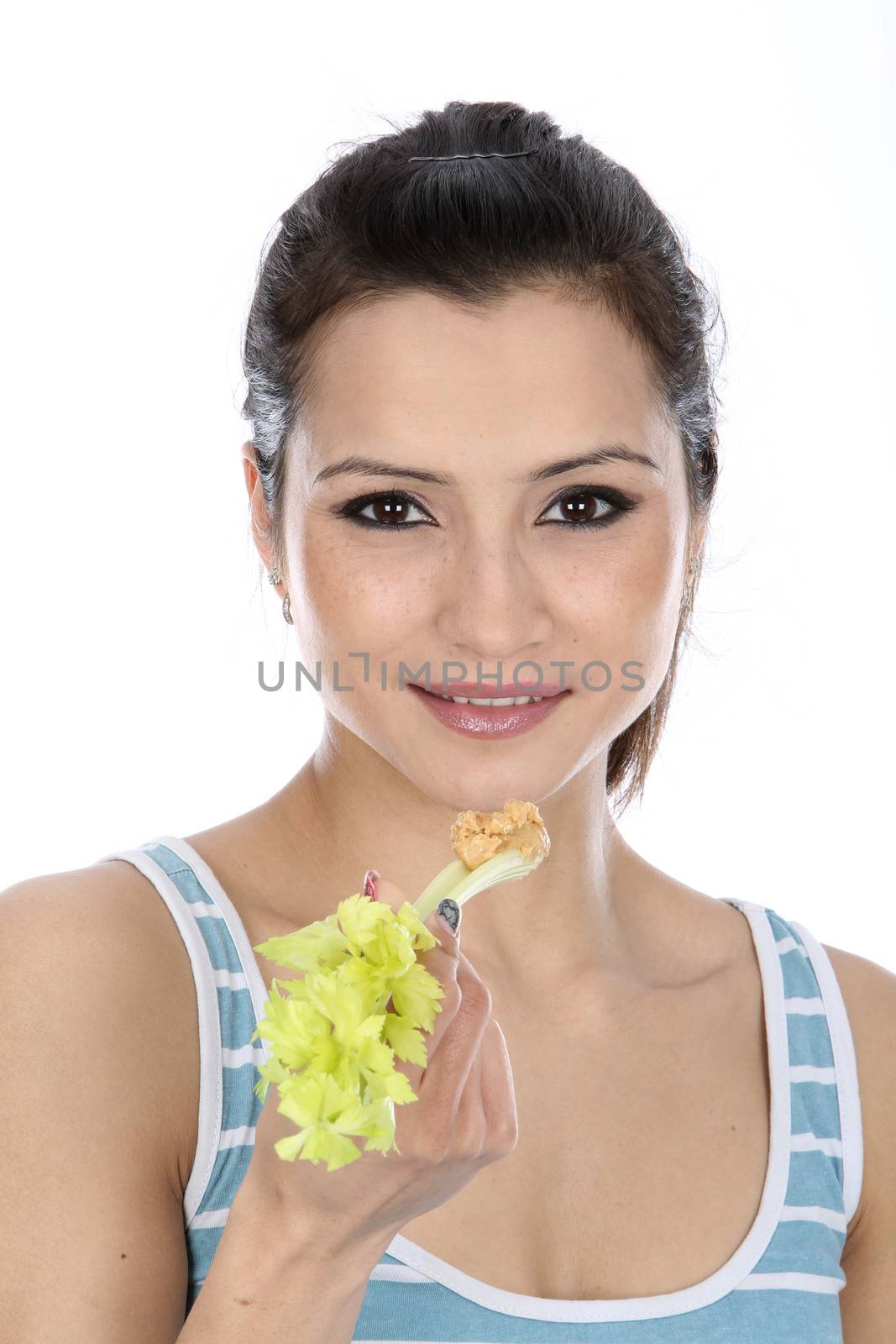 Model Released. Woman Eating Celery and Peanut Butter