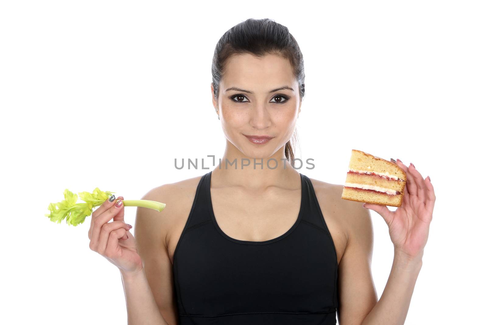 Model Released. Woman Holding comparing good bad food Cake and Celery