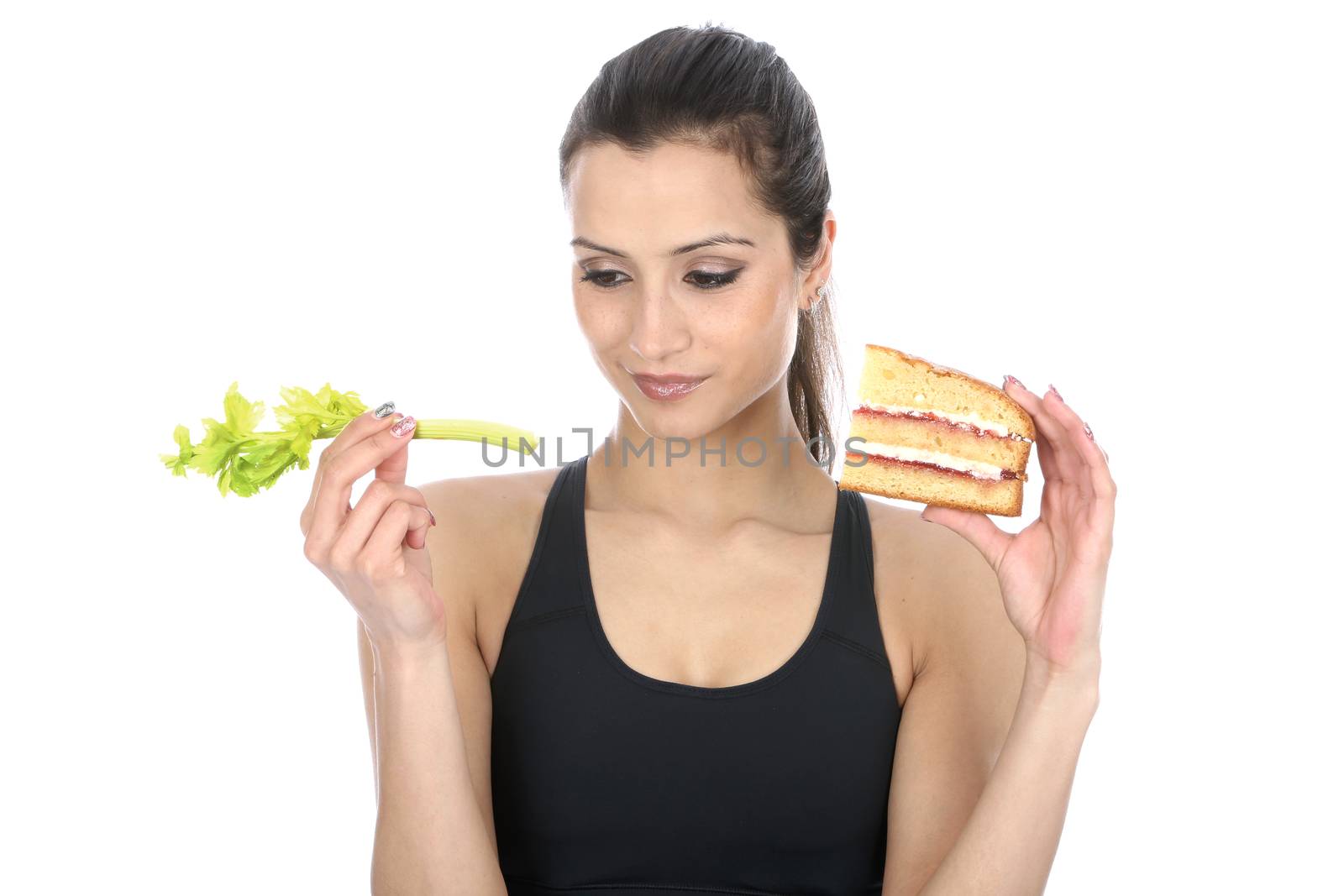 Model Released. Woman Holding comparing good bad food Cake and Celery