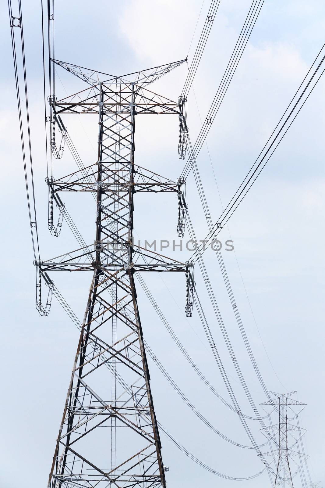 High voltage electricity pylon and blue sky