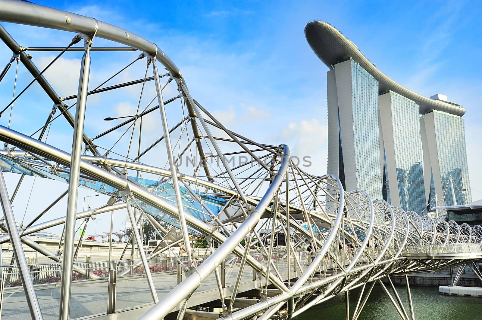 Singapore, Republic of Singapore - May 03, 2013: The Helix Bridge and Marina Bay Sands in Singapore. The Helix is fabricated from 650 tonnes of Duplex Stainless Steel and 1000 tonnes of carbon steel.