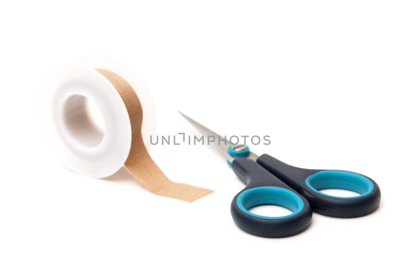 scissors with tape on a white background