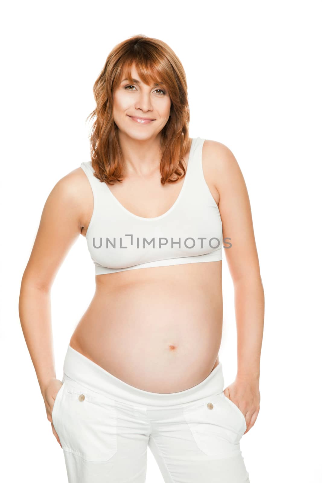 Pregnant woman smiling at camera isolated on white