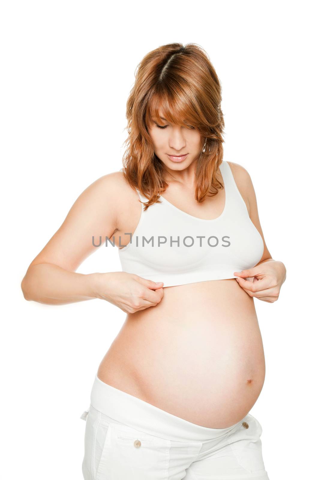 Pregnant woman looking down at bra, isolated on white