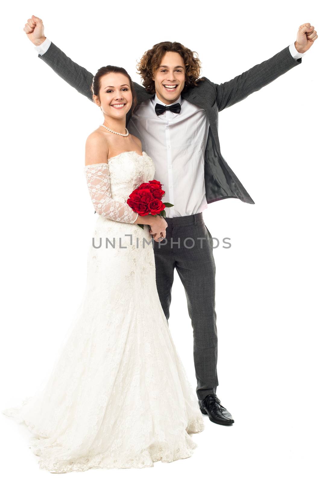 Full length portrait of excited groom posing beside his beloved wife