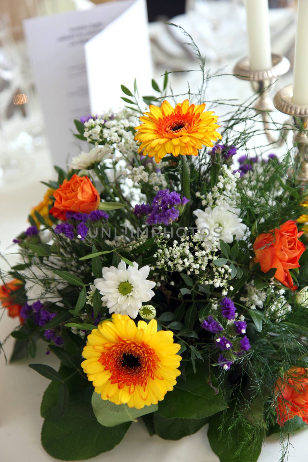 Colorful flower centerpiece on a table set for a formal meal