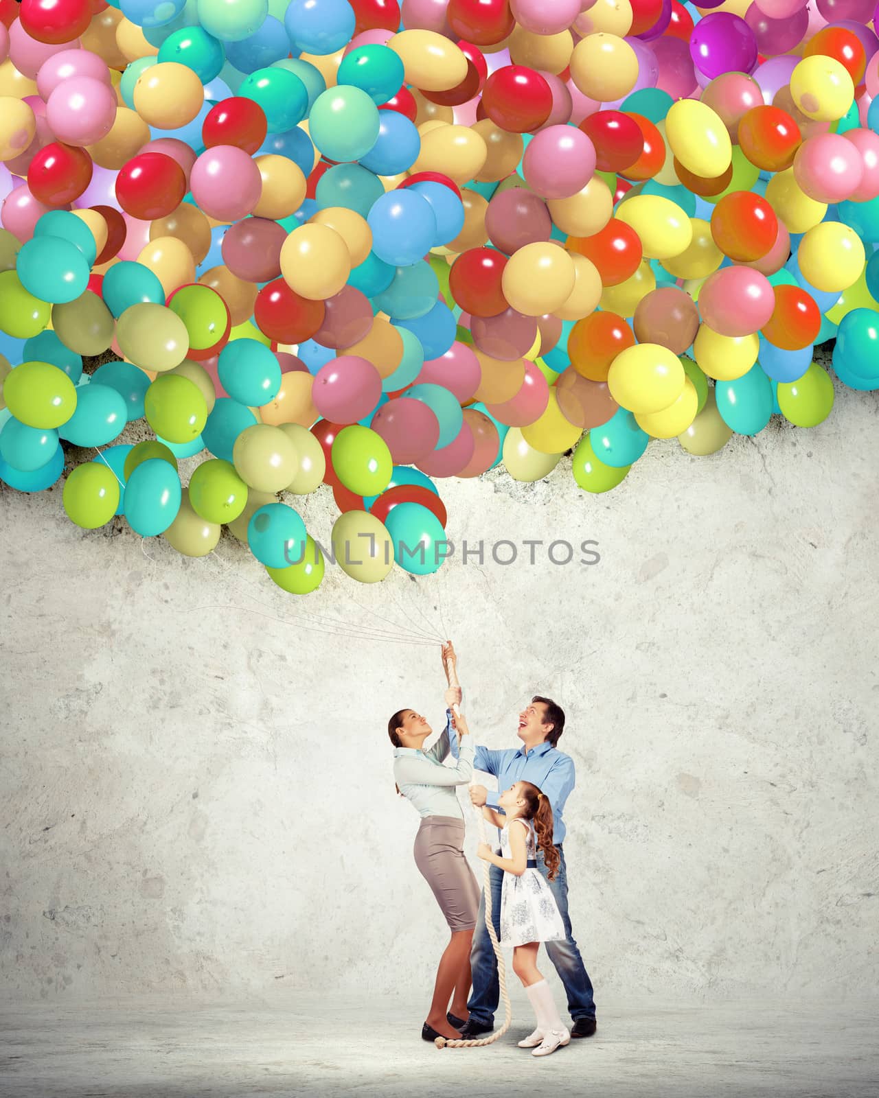 Image of happy family holding bunch of colorful balloons