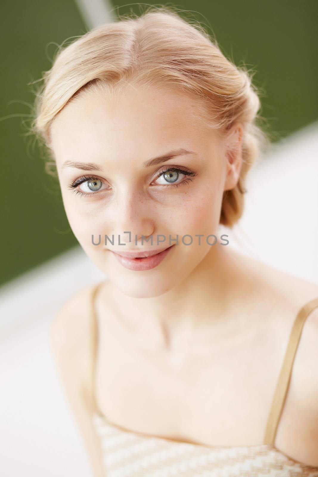 Young female teacher standing near blackboard at school