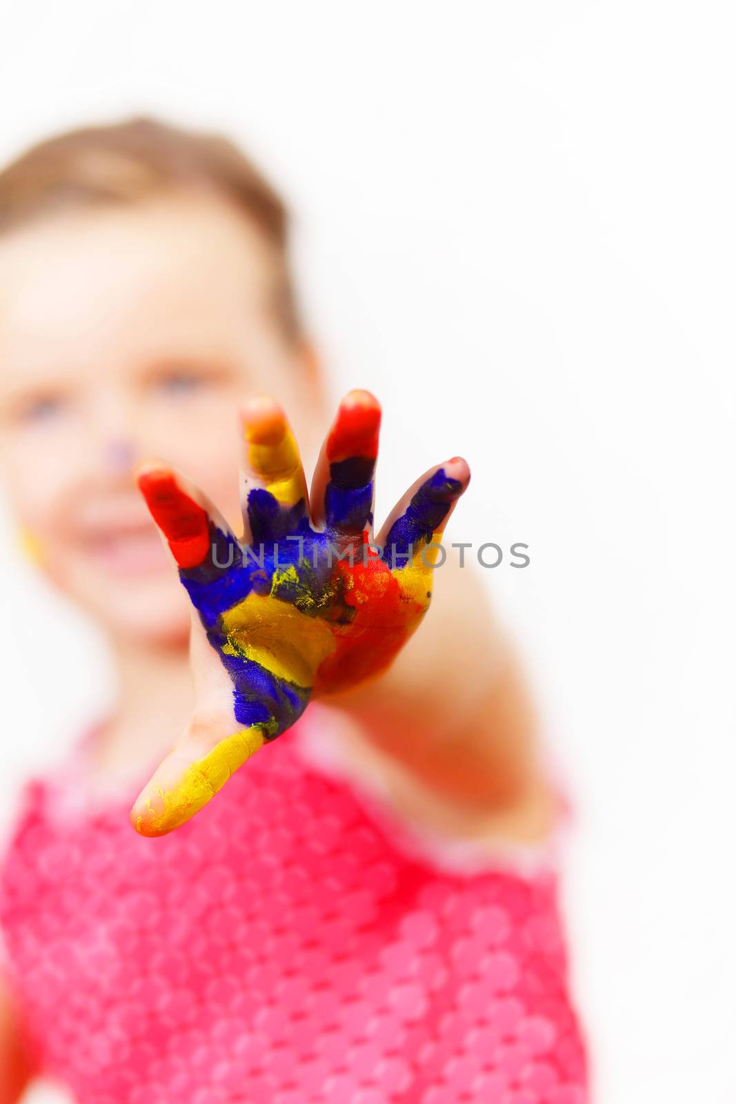 little child with hands painted in colorful paints ready for hand prints